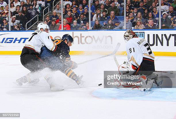 Jason Pominville of the Buffalo Sabres gets stopped by Lubomir Visnovsky and Curtis McElhinney of the Anaheim Ducks at HSBC Arena on December 21,...