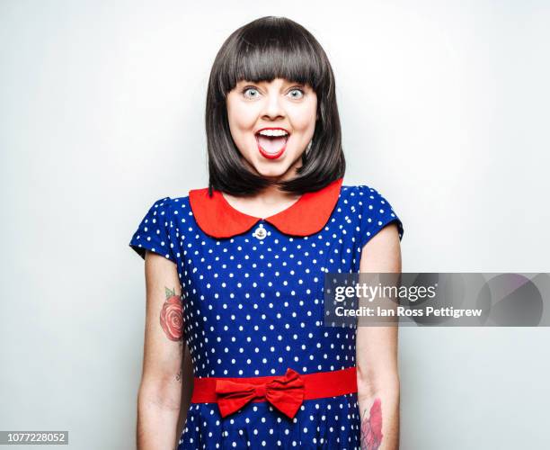 young woman in red and blue polka dot dress - caucasian ethnicity photos stock pictures, royalty-free photos & images