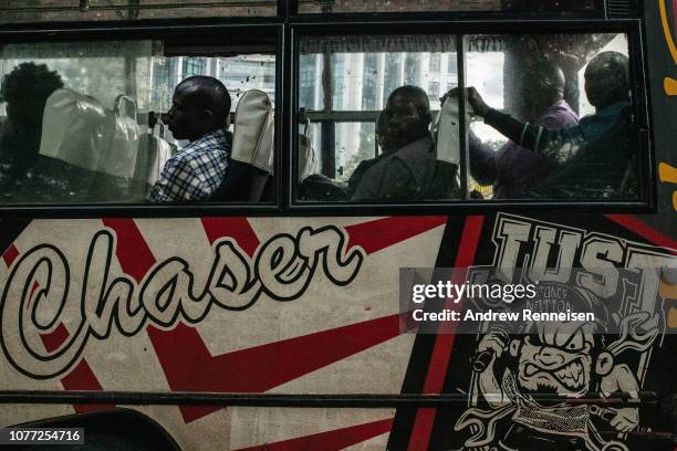 Matatu, loaded with passengers waits at a bus stop on December 04, 2018 in Nairobi, Kenya. The private minibuses were to have been banned from the...