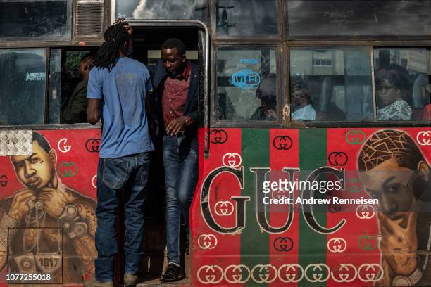 Matatu, with a mural of American hip hop artists passes a bus stop on December 04, 2018 in Nairobi, Kenya. The private minibuses were to have been...