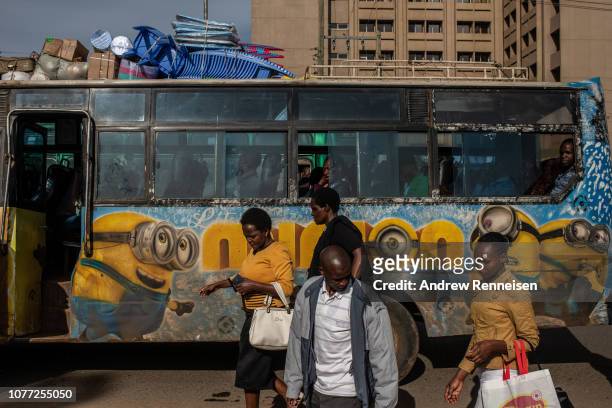 Matatu, with a mural of the American comedy film characters, Minions, passes a bus stop on December 04, 2018 in Nairobi, Kenya. The private minibuses...