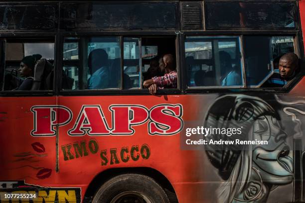 Matatu waits for more passengers at a bus stop on December 04, 2018 in Nairobi, Kenya. The private minibuses were to have been banned from the city's...