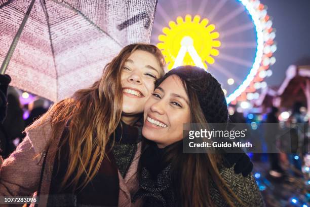 happy girlfriends at christmas market. - annual companions stock pictures, royalty-free photos & images