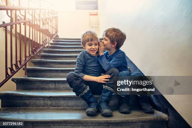 little boys whispering secrets - toned image stock pictures, royalty-free photos & images