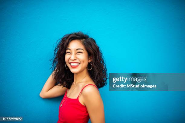 portrait of a smiling asian woman - curly hair stock pictures, royalty-free photos & images