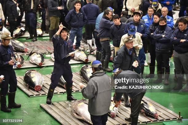 Wholesalers participate in the new year's first auction of Tuna at the Toyosu Market in Tokyo on January 5, 2019. - A record $3.1 million was paid...