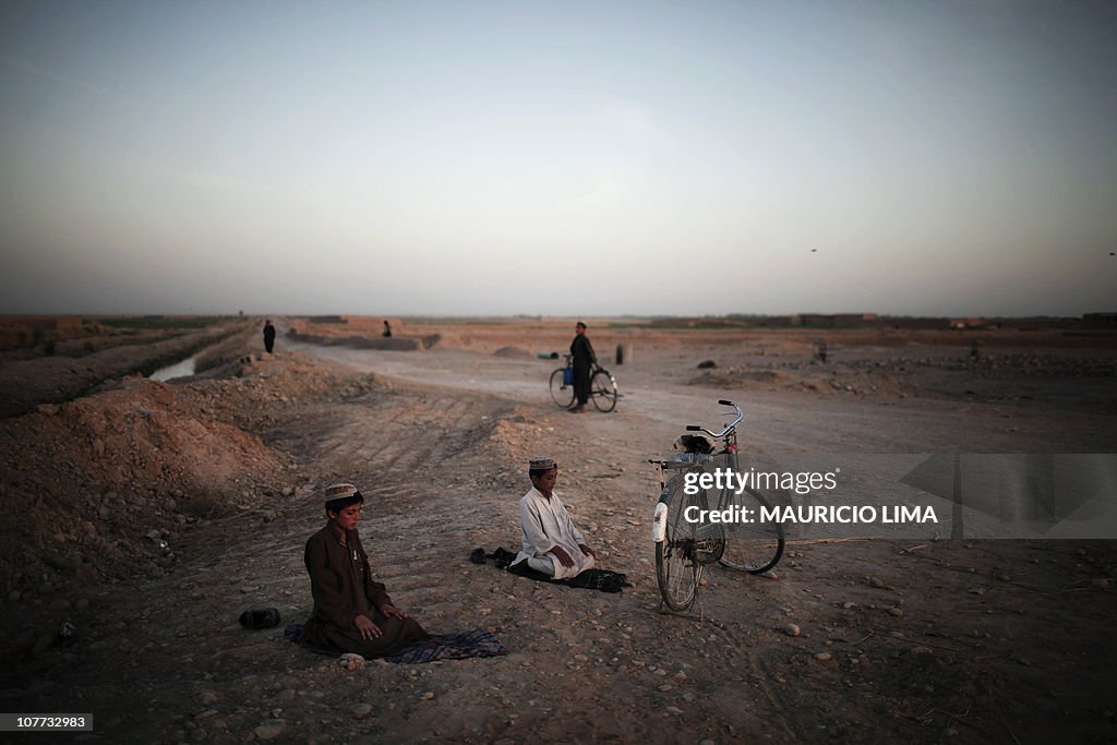 A couple of Afghan boys stops to ride on