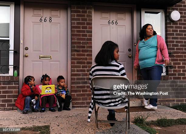 Left to right, Seiana Warren Iyana Warren Jaelen Rollins, Briana Wilson, and Taknisha Warren sit outside residents in a townhouse community near a...