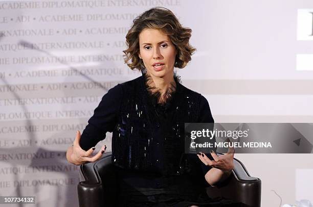 Syrian president Bashar al-Assad's wife Asma gestures as she speaks during a meeting at the International diplomatic academy on December 10, 2010 in...