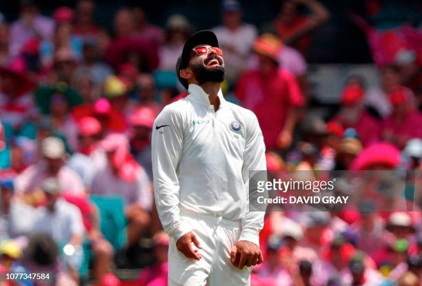 India's captain Virat Kohli reacts after fielding the ball during the third day's play of the fourth and final cricket Test between India and...