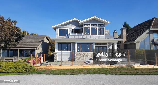 construction of a new shingle style and stone home - terrace british columbia stock pictures, royalty-free photos & images