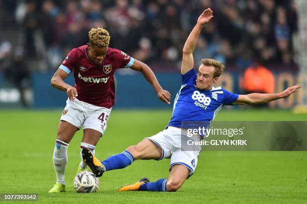 West Ham United's English midfielder Grady Diangana is tackled by Birmingham City's Dutch midfielder Maikel Kieftenbeld during the English FA Cup...