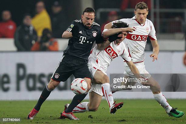 Franck Ribery of Muenchen is challenged by Christian Traesch and Pavel Pogrebnyak of Stuttgart during the DFB Cup round of sixteen match between VfB...