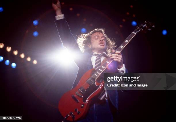 Australian guitarist Angus Young of AC/DC plays in his schoolboy-uniform during the Flick of the Switch Tour on November 17, 1983 at Joe Louis Arena...