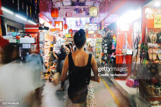 woman traveller in the busy markets of singapore - singapore tourist stock pictures, royalty-free photos & images