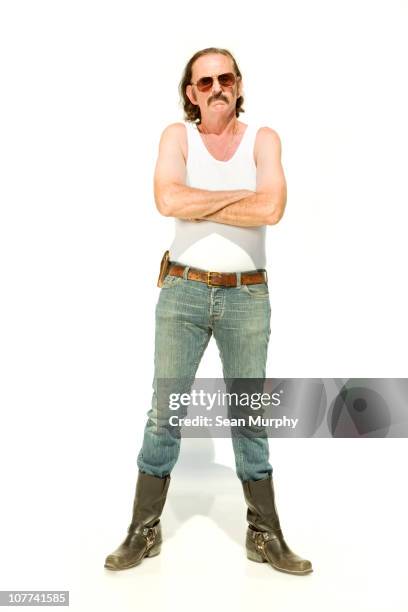 man standing on white seamless with crossed arms - man in tank top stock pictures, royalty-free photos & images