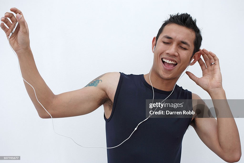 Young man listening to music on an MP3 player