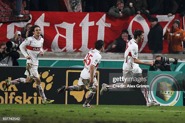 Matthieu Delpierre of Stuttgart celebrates his team's third goal with team mates Christian Traesch and Christian Gentner during the DFB Cup round of...