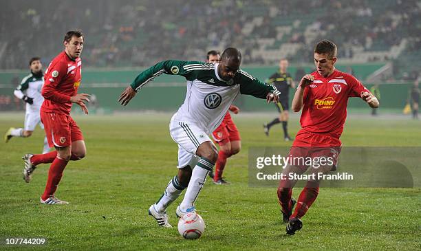 Grafite of Wolfsburg is challenged by Velimir Jovanovic of Cottbus during the DFB Cup last 16 match between VfL Wolfsburg and Energie Cottbus at the...