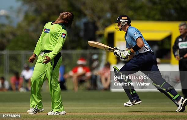 Shoaib Akhtar of Pakistan shows his frustration as Martin Guptill of the Aces runs during the Twenty20 trial match between Pakistan and the Auckland...