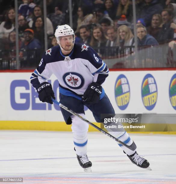 Cameron Schilling of the Winnipeg Jets skates against the New York Islanders at the Barclays Center on December 04, 2018 in the Brooklyn borough of...