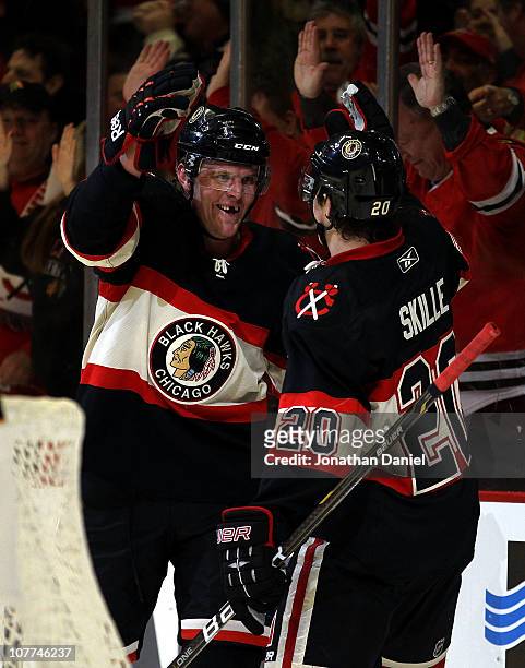 Bryan Bickell of the Chicago Blackhawks celebrates his 3rd period goal with teammate Jack Skille against the Nashville Predators at the United Center...