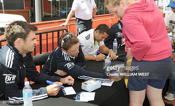 England batsman Ian Bell signs an autograph on the shorts of a fan as teammate James Anderson looks on during a public appearance of the Australian...