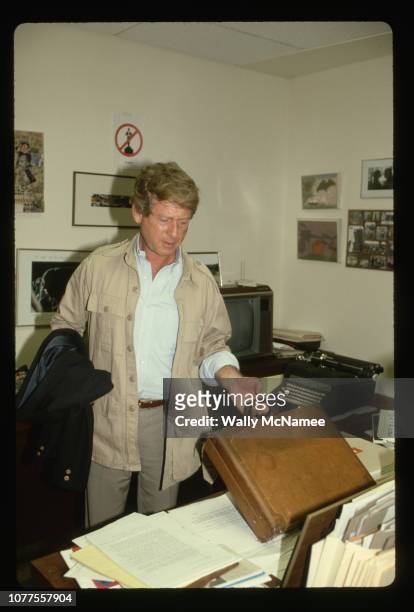 Recently returned from a day of working in the field, ABC News broadcaster Ted Koppel settles into his office to begin working on the evening's...