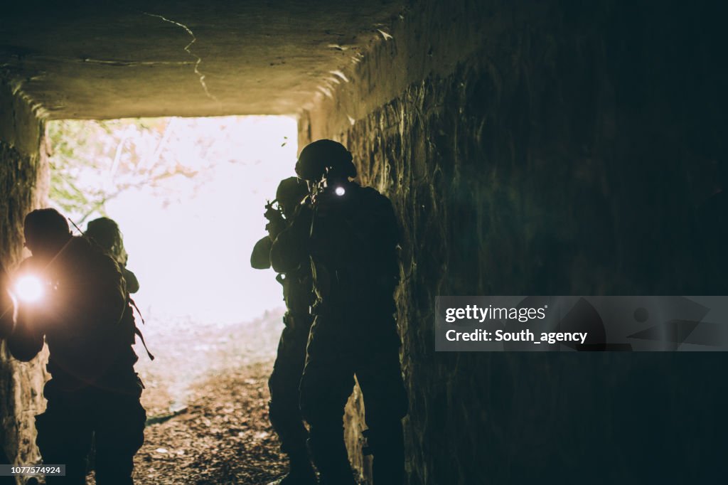 Soldiers in dark cave