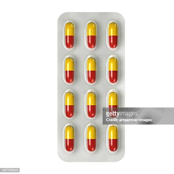 red and yellow capsules with medicine - capsule medicine ストックフォトと画像