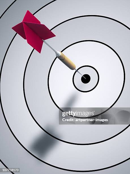 a dart hitting bulls eye on a dartboard - target stock pictures, royalty-free photos & images