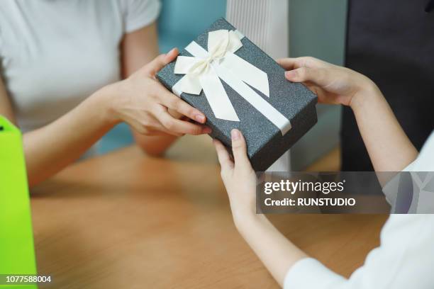 close up of friends giving gift box - exchanging gift stock pictures, royalty-free photos & images