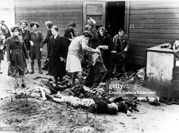 Bergen-Belsen Concentration Camp, Liberated women stripping the dead of their clothing for after camp has been turned over to the Allied 21st Army...