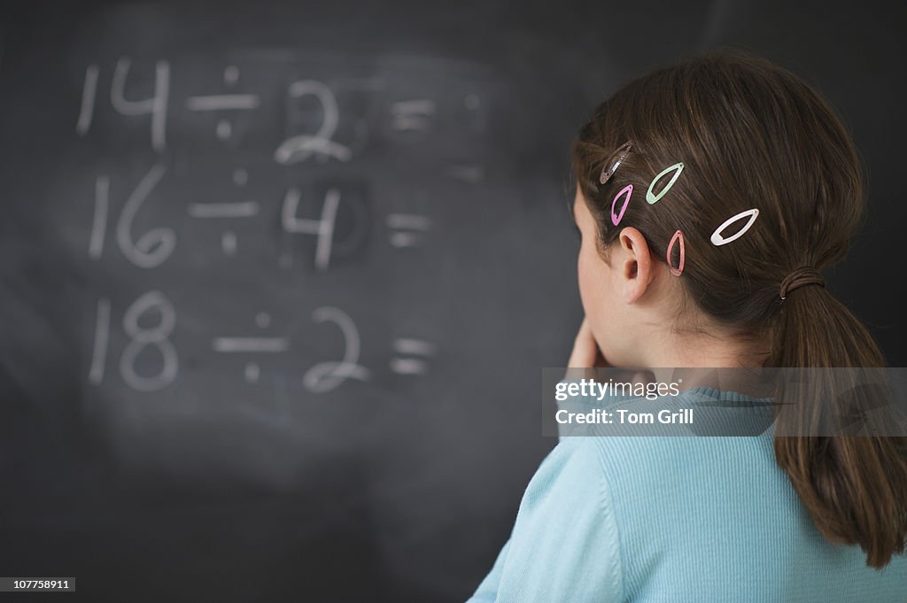 Student Looking At Math Girl Looking At Math Equations On Blackboard High-Res Stock Photo ...