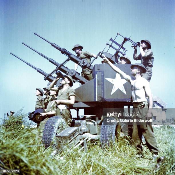 Operation Overlord Normandy, Soldiers of the 3rd Canadian Infantry Division have set up anti-aircraft guns on Juno Beach where they landed on D-Day...