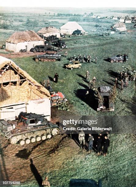 Operation Barbarossa, Tanks and other vehicles have arrived in a small rural village on the Eastern front. 1942. A Nazi flag has been placed near the...