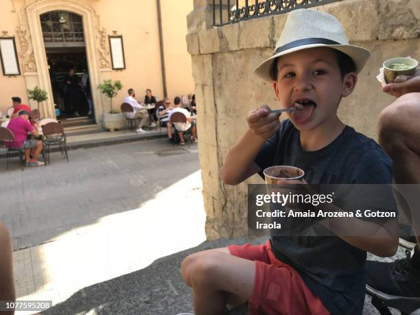 little boy savoring the famous italian ice cream in noto, sicily - noto sicily stock pictures, royalty-free photos & images