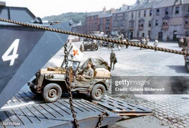 Operation Overlord Normandy, A United States Army ambulance jeep is entering a Landing Craft Transport in a port in Southern England. June 1944. The...