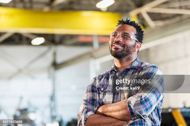 african-american man in metal fabrication plant - black man plaid shirt stock pictures, royalty-free photos & images