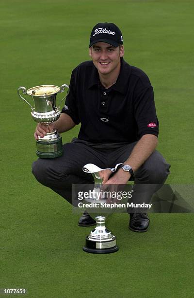 Ian Poulter of England celebrates with the trophys after his first PGA European Tour win after a one shot victory in the final round of the Italian...