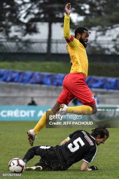 Duchere's French defender Salim Moizini jumps over Nimes' Algerian defender Fethi Harek during the French Cup round of 32 football match between La...