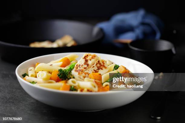 roasted butternut squash pasta bowl with grilled halloumi cheese - penne stock pictures, royalty-free photos & images