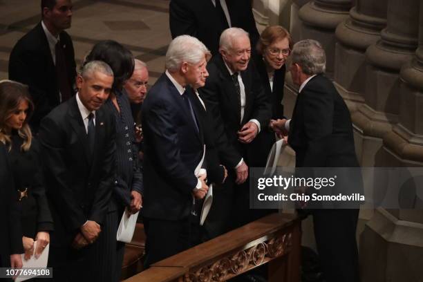 Former U.S. President George W. Bush greets fellow former presidents Jimmy Carter, Bill Clinton and Barack Obama and first ladies Rosalynn Carter,...
