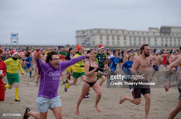Participants rush into the water during a New Year's Plunge on a cold day on January 5, 2019 in Ostend, Belgium.