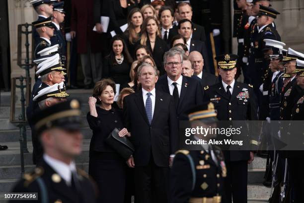Former U.S. President George W. Bush, his wife Laura Bush, his brothers Jeb Bush and Neil Bush and other members of the Bush family watch a joint...