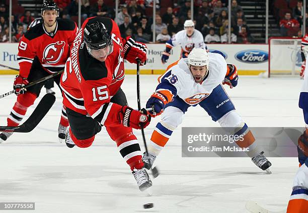 Jamie Langenbrunner of the New Jersey Devils shoots the puck against Jon Sim of the New York Islanders at the Prudential Center on December 23, 2010...