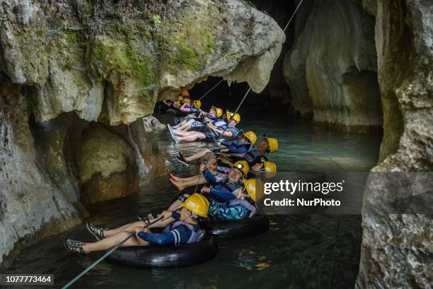 Korean tourists have a water cave tour in Vang Vieng, Laos, in December 2018. Since the end of the 90s, Vang Vieng has been opened as a tourist site...