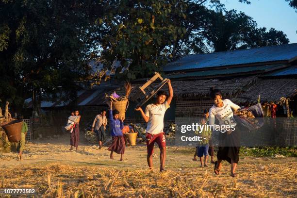 This picture taken on January 4, 2019 shows people, displaced by violence between ethnic Rakhine rebels and Myanmar's army, arriving at a camp in...