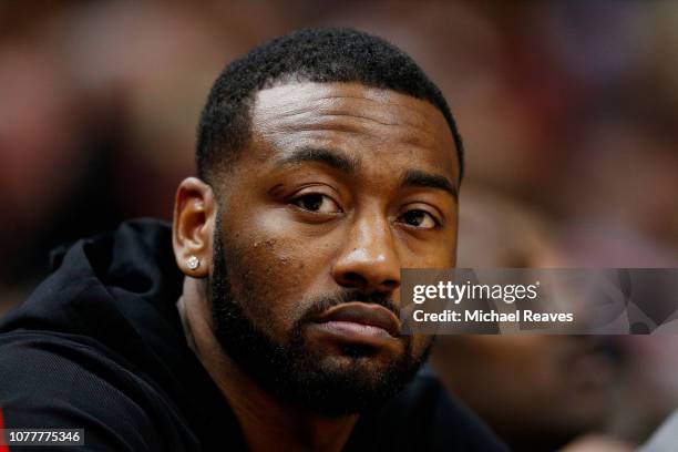 John Wall of the Washington Wizards looks on from the bench against the Miami Heat at American Airlines Arena on January 4, 2019 in Miami, Florida....