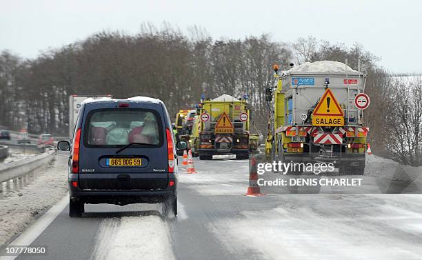 Trucks salt the A26 highway on December 24, 2010 near Cambrai, northern France after heavy snowfalls. The cold hit air, rail and road transport...
